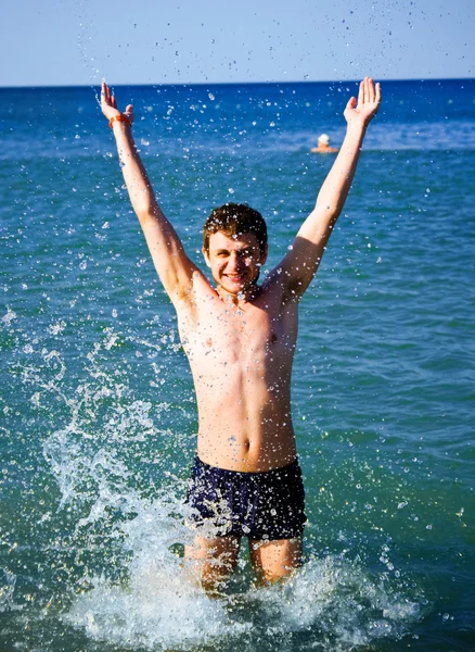 Young man coming out from the water — Stock Photo, Image