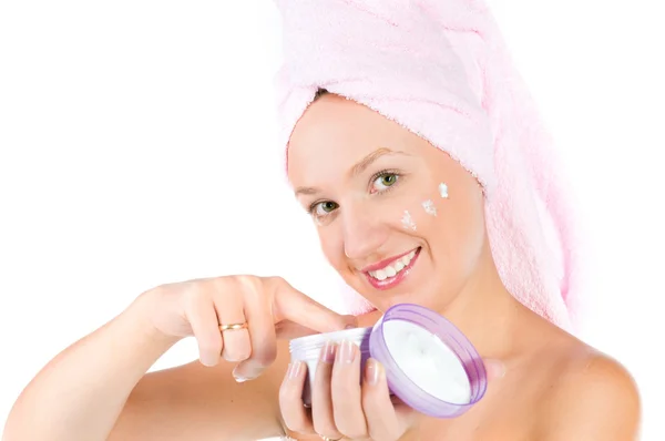 Young woman with towel on her head and cream. — Stock Photo, Image