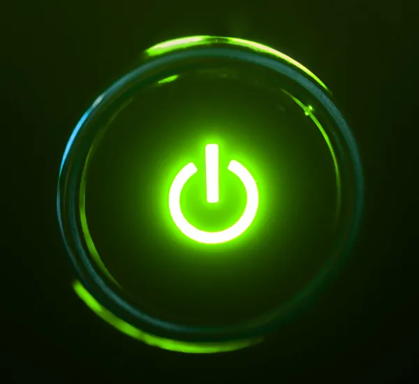 Monitor botão de energia close-up na escuridão — Fotografia de Stock