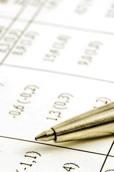 Close up of financial figures and pen — Stock Photo, Image