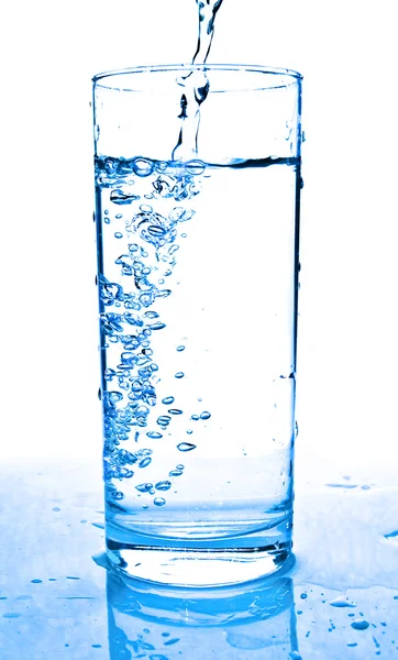 Glass of water being poured — Stock Photo, Image
