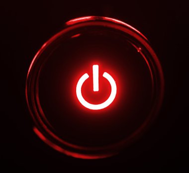 Monitor power button closeup in darkness clipart