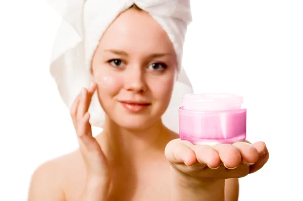Young girl with towel on her head and cream. — Stock Photo, Image