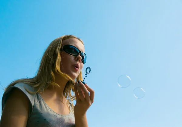 Girl playing with lots of soap bubbles — Stock Photo, Image