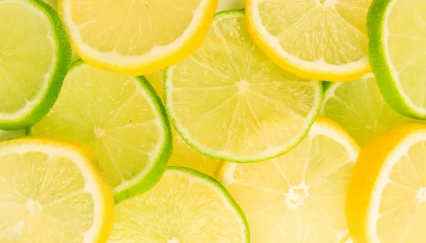 Lemon and lime slices abstract background — Stock Photo, Image