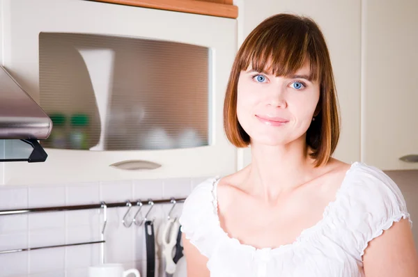 Young attractive brunette in the kitchen — Stock Photo, Image