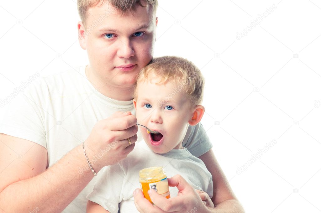 Man feeding baby with a spoon, on white background
