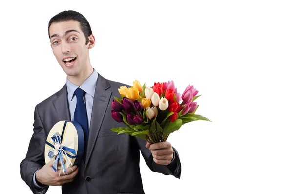 Empresário com caixa de presente e flores — Fotografia de Stock