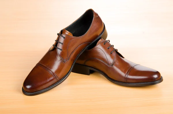 Bruna skor på träbord — Stockfoto