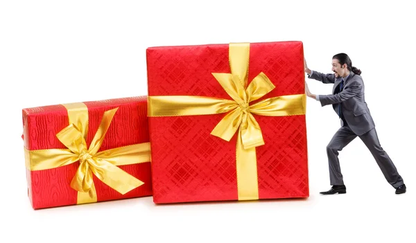 Businessman with gift boxes on white — Stock Photo, Image