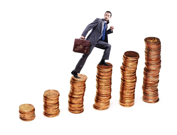 Businessman climbing gold coins stacks — Stock Photo, Image