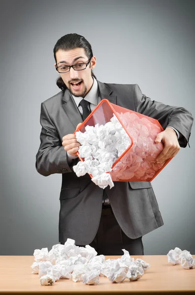 Man with lots of wasted paper Stock Photo