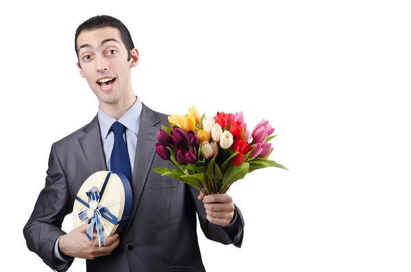 Affärsman med presentask och blommor — Stockfoto