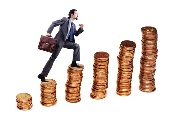 Empresário escalando pilhas de moedas de ouro — Fotografia de Stock