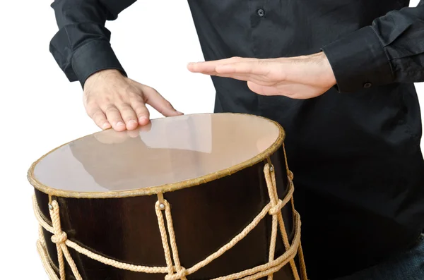 Drummer with drum playing on white Stock Picture