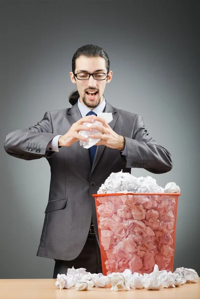 Man with lots of wasted paper Stock Photo