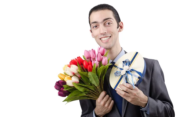 Бизнесмен с подарком и цветами — стоковое фото