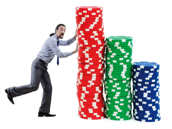 Бизнесмен и фишки казино на белом — стоковое фото
