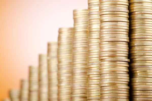 Golden coins in high stacks — Stock Photo, Image