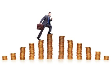 Businessman climbing gold coins stacks clipart