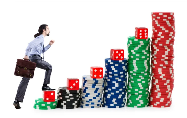 Businessman climbing stacks of casino chips — Stock Photo, Image