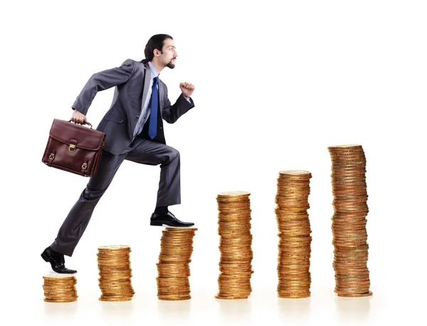 Empresário escalando pilhas de moedas de ouro — Fotografia de Stock