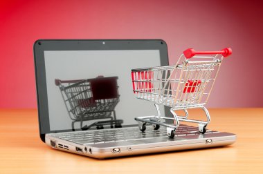 Internet online shopping concept with computer and cart clipart