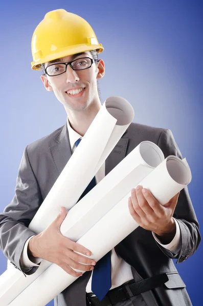 Young architect with drawings and hardhat — Stock Photo, Image