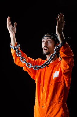 Inmate chained on black background clipart