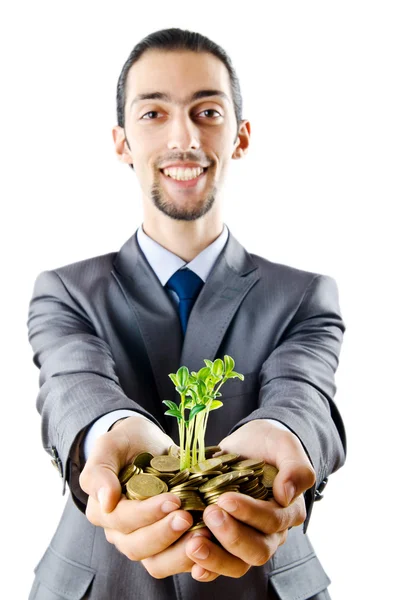 Businessman with gold seedlings and coins — Stock Photo, Image