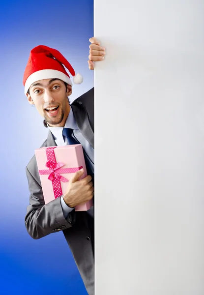 Businessman in santa hat with blank message — Stock Photo, Image