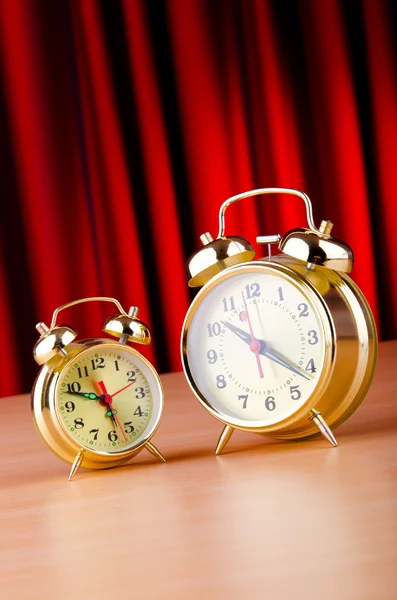 Alarm clock against curtain — Stok fotoğraf