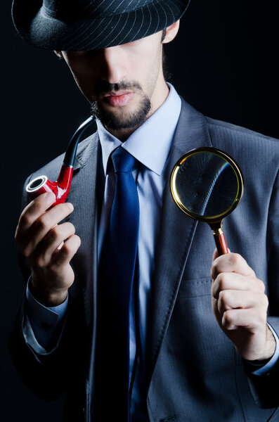 Detective with magnifying glass and pipe