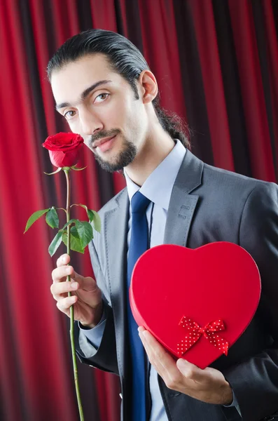 Young man with red rose — Stock Photo, Image