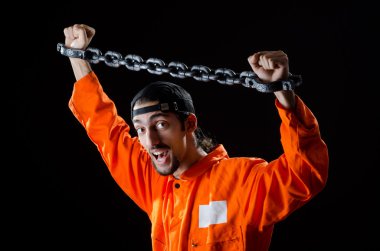 Inmate chained on black background clipart