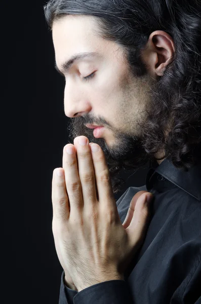 Młody człowiek modli się w ciemności — Zdjęcie stockowe