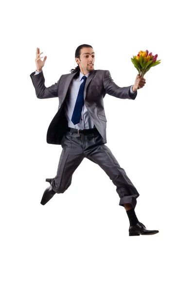 Giovane uomo con fiori di tulipano — Foto Stock