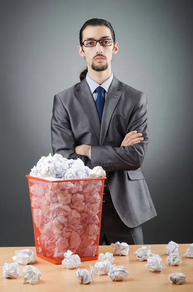 Man with lots of wasted paper Stock Image