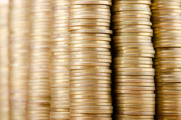 Golden coins in high stacks — Stockfoto