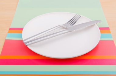 Emtpy plates with utensils on table clipart