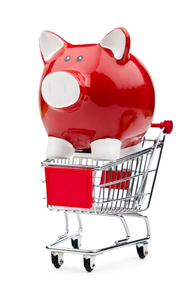 Piggy bank en winkelwagentje op wit — Stockfoto