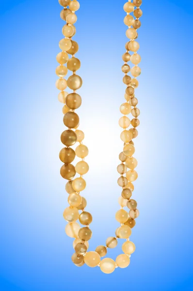 Nice necklace against gradient background — Stock Photo, Image