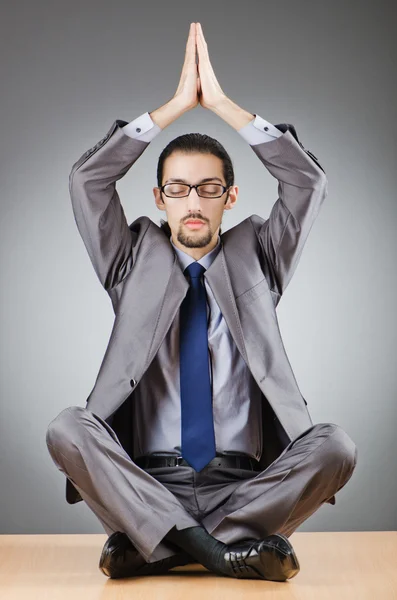Businessman meditating sitting on the desk — Stock Photo, Image