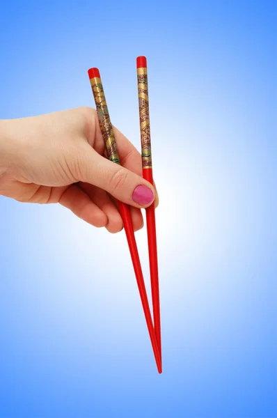 Hand met choipsticks op helling — Stockfoto