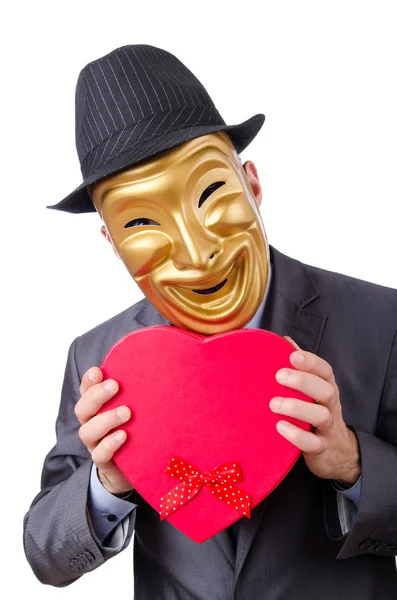 Masked man with giftbox on white — Stock Photo, Image