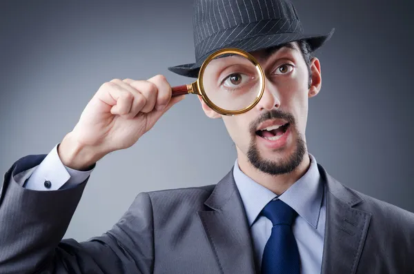 Detective and magnifying glass — Stock Photo, Image