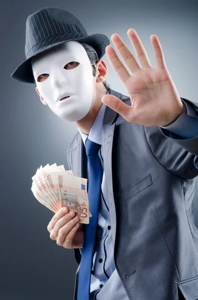 Бизнесмен с деньгами и маской — стоковое фото