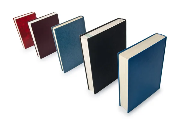 Knihy ve vysokém zásobníku izolované na bílém — Stock fotografie