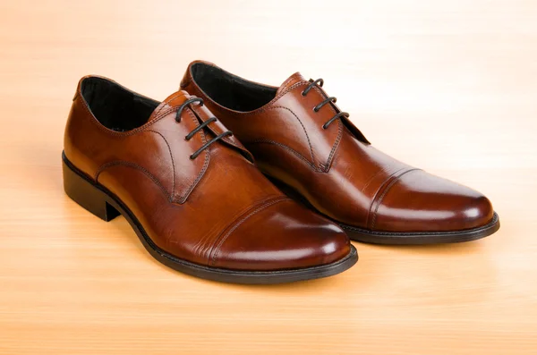 Zapatos marrones en mesa de madera — Foto de Stock