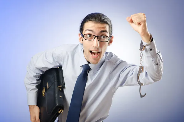 Businessman with handcuffs running away — Stock Photo, Image